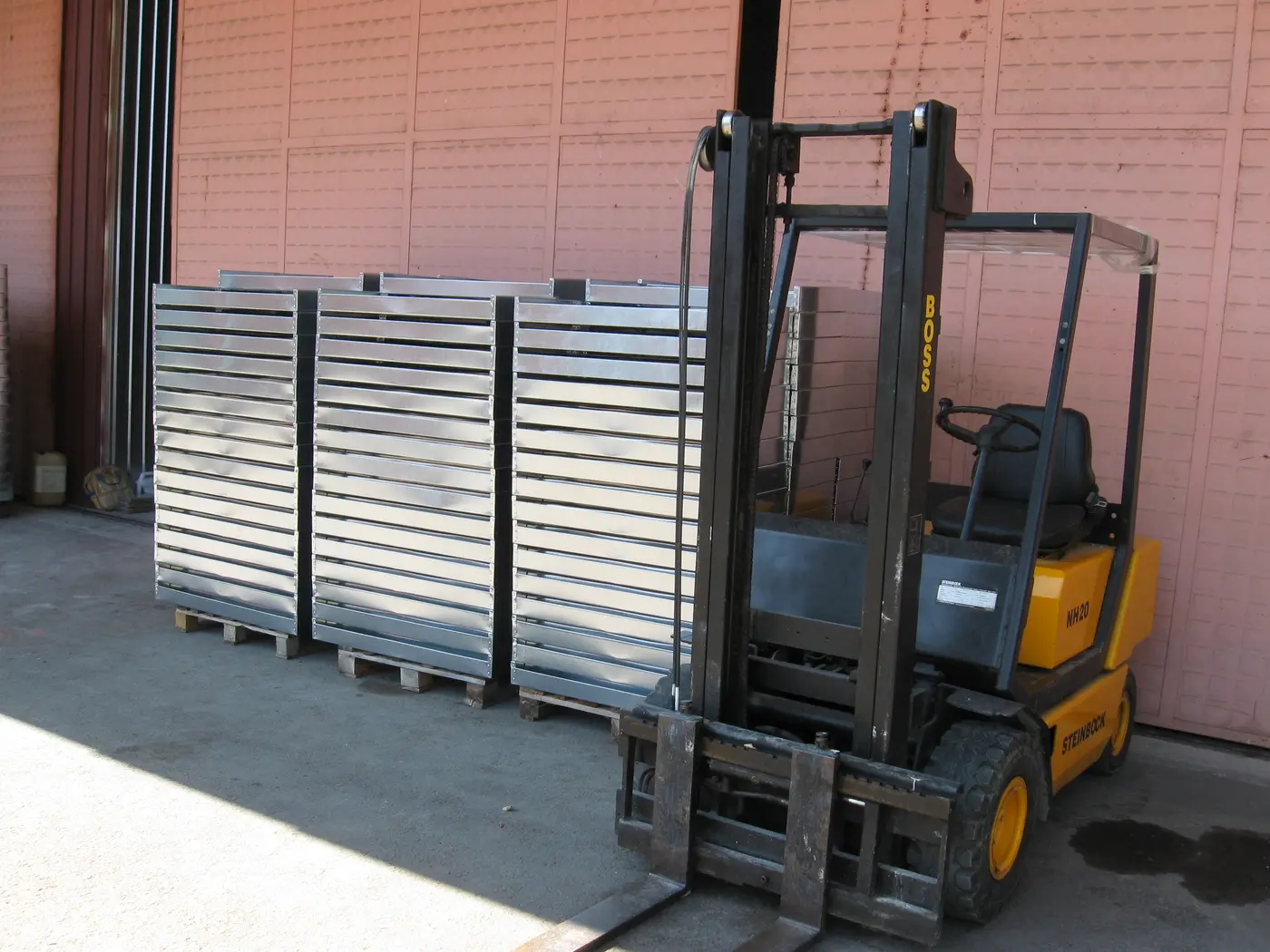 Forklift loading pallets of trays — same-day dispatch from our own stock
